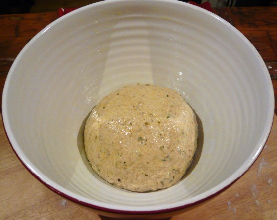 Ball of dough in a high-sided, cermaic bowl.