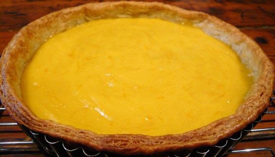 Tart shell with pink grapefruit curd filling.